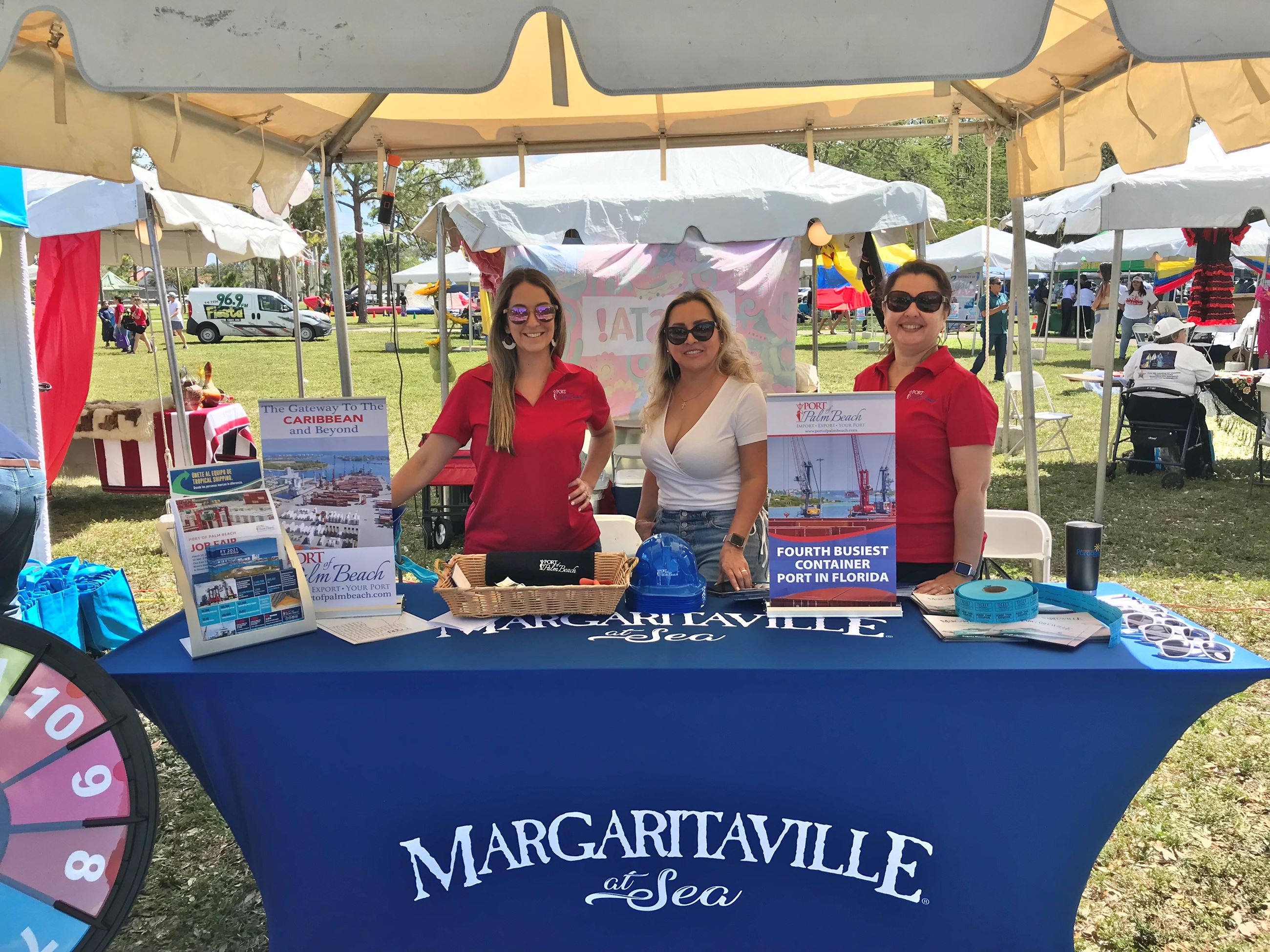 Yaremi Farinas, Nasly Osorio, Jackelin Machado working booth at Fiesta de Pueblo & Business Expo