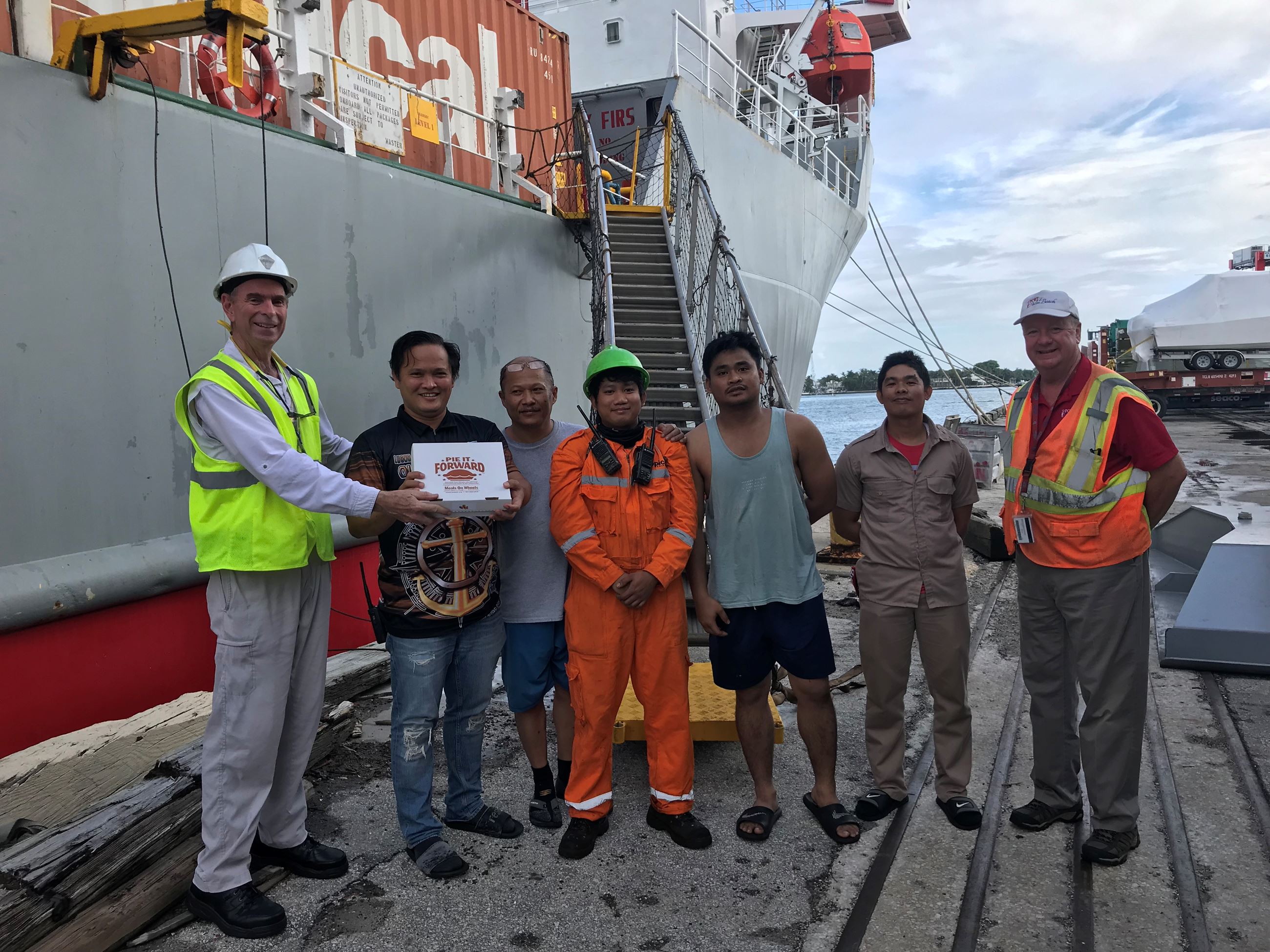 Tropical Shipping crew receiving pie donation