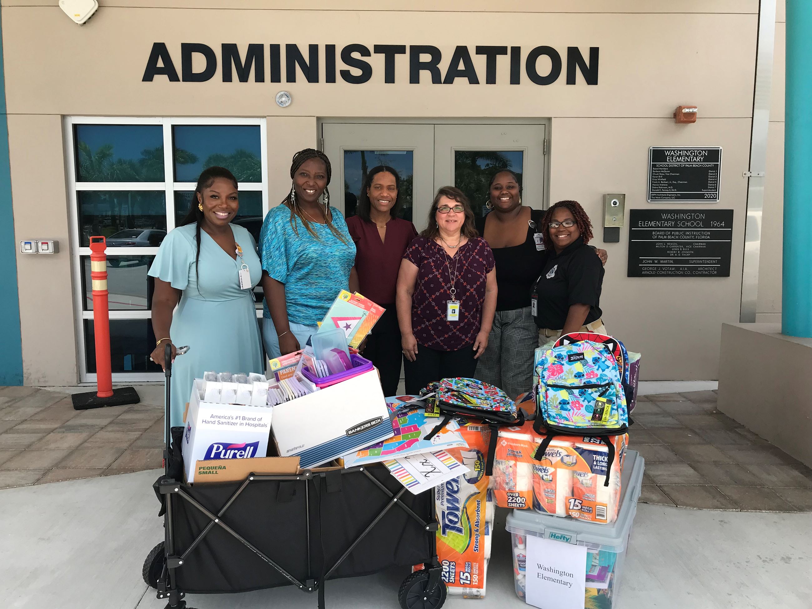 VP of Heavy Lift Tina Dias and PIO Yaremi Farinas with Washington Principal Dr. Murray